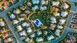 Aerial drone view of the harbor and the beach of Cala en Bosc, M